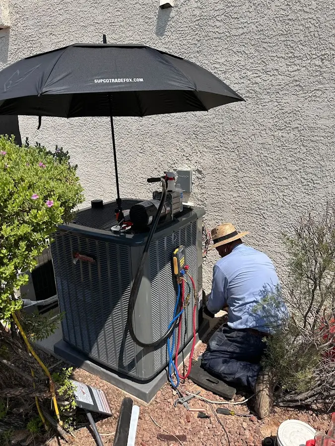 HVAC technician performing outdoor AC maintenance in Moore